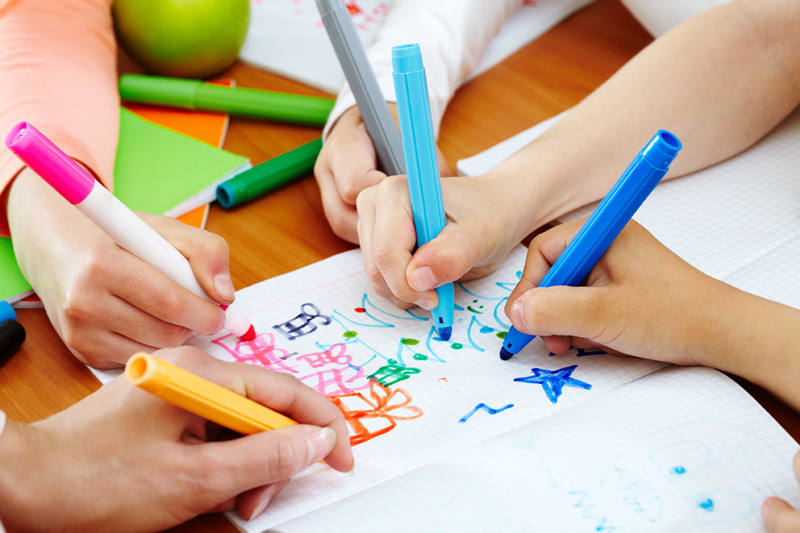 Children drawing in a book. A great way to create a truly personalised and bespoke album.
